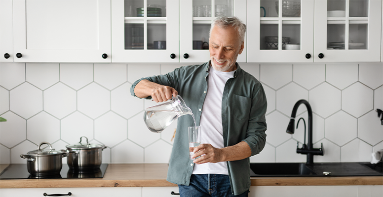 A man getting a glass of purified reverse osmosis water